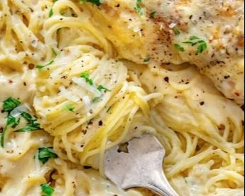 Crock Pot Angel Chicken dish ready to serve with side vegetables.