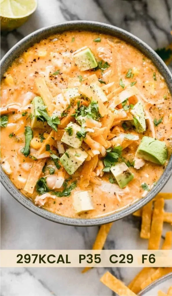 Bowl of healthy high protein white chicken chili garnished with cilantro and lime.