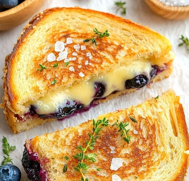 Juicy blueberry grilled cheese sandwich with melted cheese and fresh blueberries