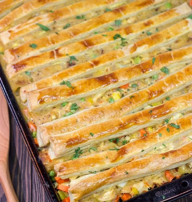 Delicious sheet pan chicken pot pie served on a wooden table