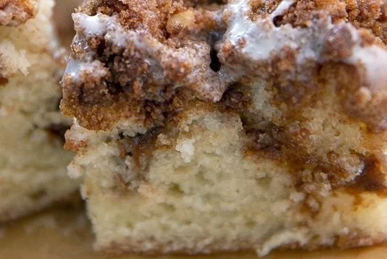 Delicious homemade coffee cake with a crumb topping and coffee cup