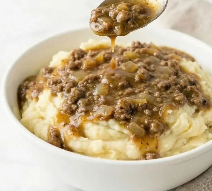 Delicious Beef Stroganoff served with creamy mashed potatoes on a plate