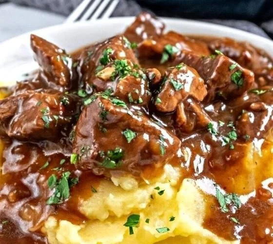 Delicious beef tips served in rich gravy over mashed potatoes