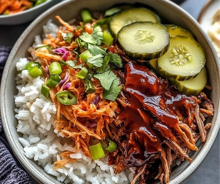 Slow cooker pulled beef bowls topped with fresh ingredients