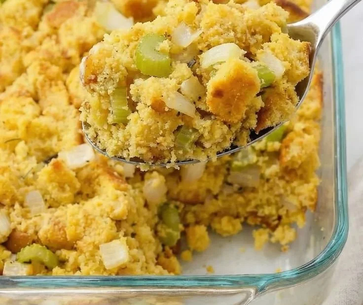 Delicious Southern cornbread dressing served in a bowl with herbs