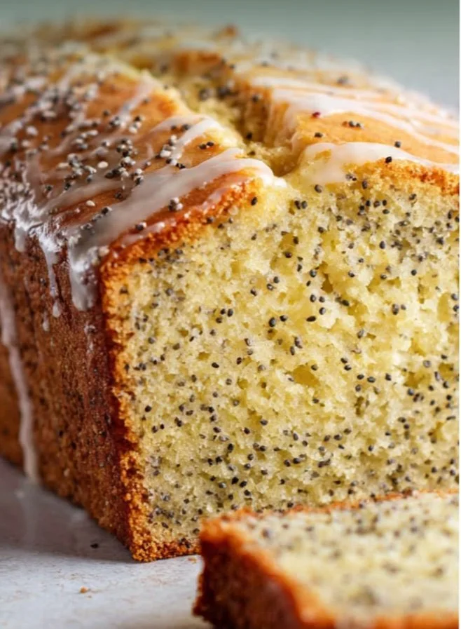 Delicious slice of Lemon Poppy Seed Loaf Cake with poppy seeds and lemon zest.