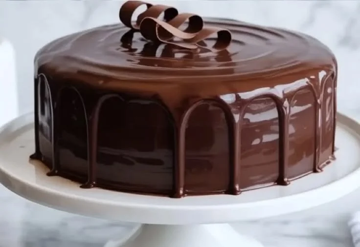 Delicious Sour Cream Chocolate Cake with rich frosting and chocolate sprinkles