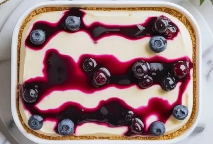 Blueberry Vanilla Cheesecake Icebox Cake slice with fresh blueberries on top