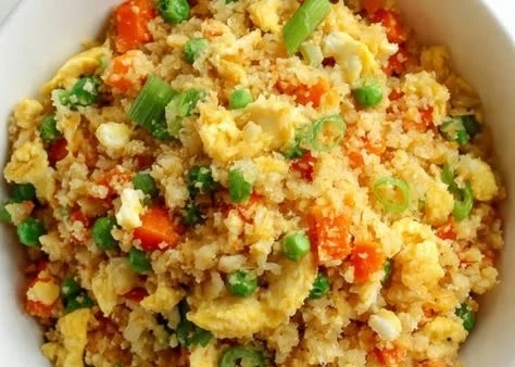 Bowl of flavorful cauliflower fried rice with vegetables and herbs