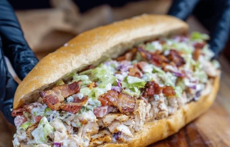 Chopped chicken bacon ranch sandwich with crispy bacon and fresh toppings