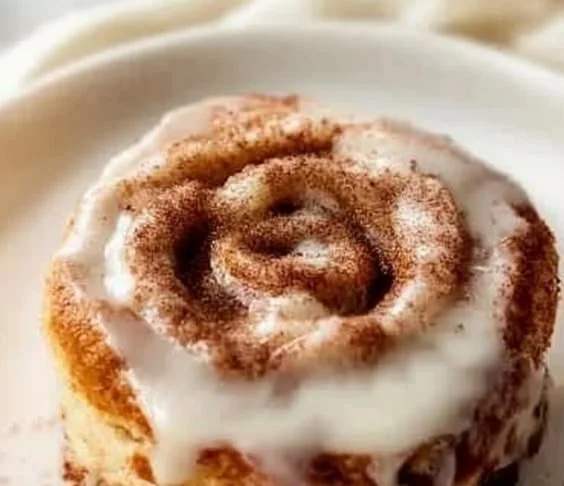 Delicious gluten free cinnamon dessert topped with icing and sprinkled cinnamon
