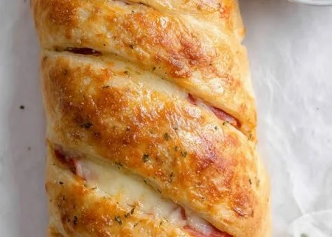 A freshly baked homemade Stromboli filled with cheese and pepperoni.