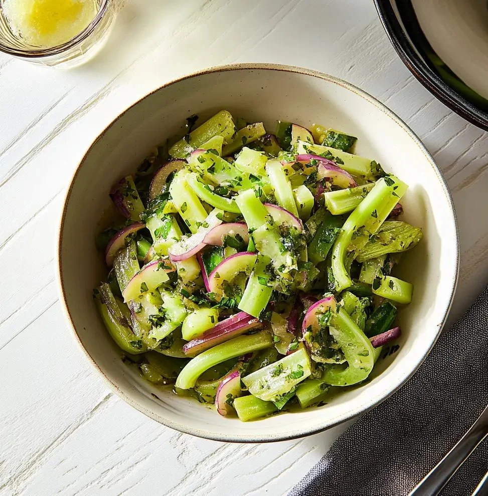 Colorful marinated celery salad with fresh herbs and spices.