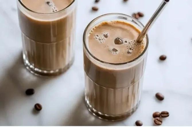 Delicious protein coffee shake garnished with coffee beans and chocolate.