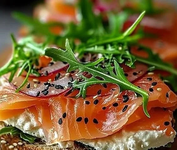 Delicious smoked salmon sandwich with cream cheese and fresh herbs