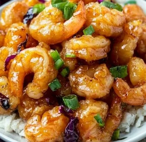 Plate of crispy Bang Bang Shrimp drizzled with spicy sauce.