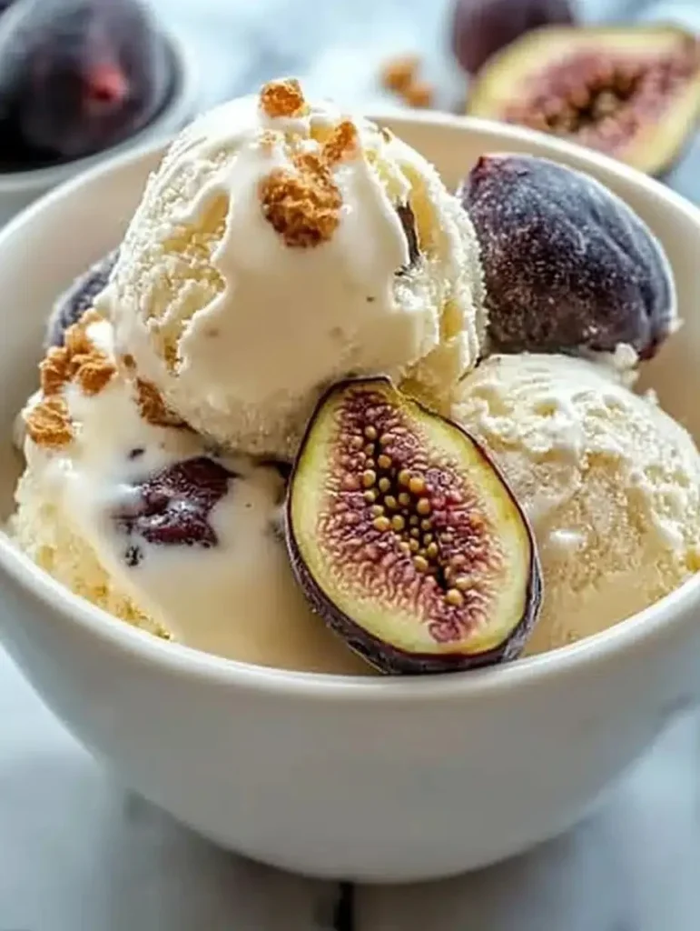 Honey-drizzled fig ricotta ice cream in a bowl, topped with fresh figs and honey.