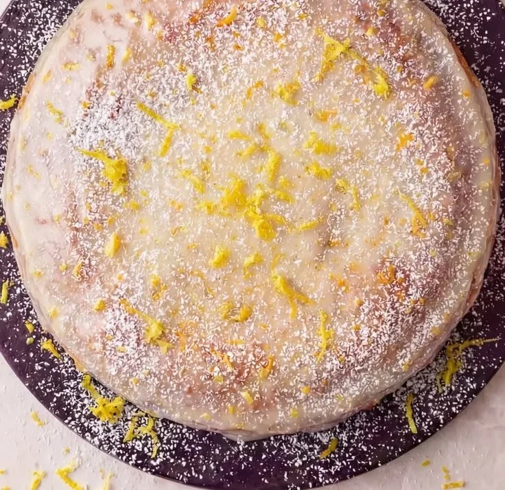 Limoncello Ricotta Cake garnished with lemon zest and fresh mint