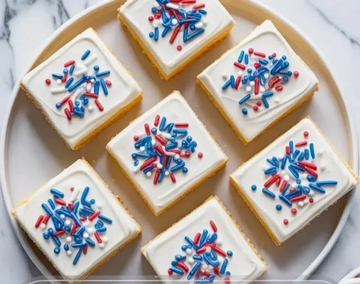 Patriotic sugar cookie bars decorated with red, white, and blue icing