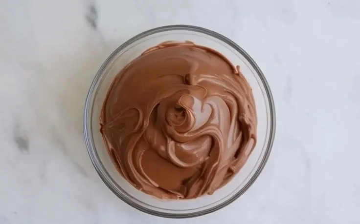 Velvety Nutella Buttercream frosting on a chocolate cupcake